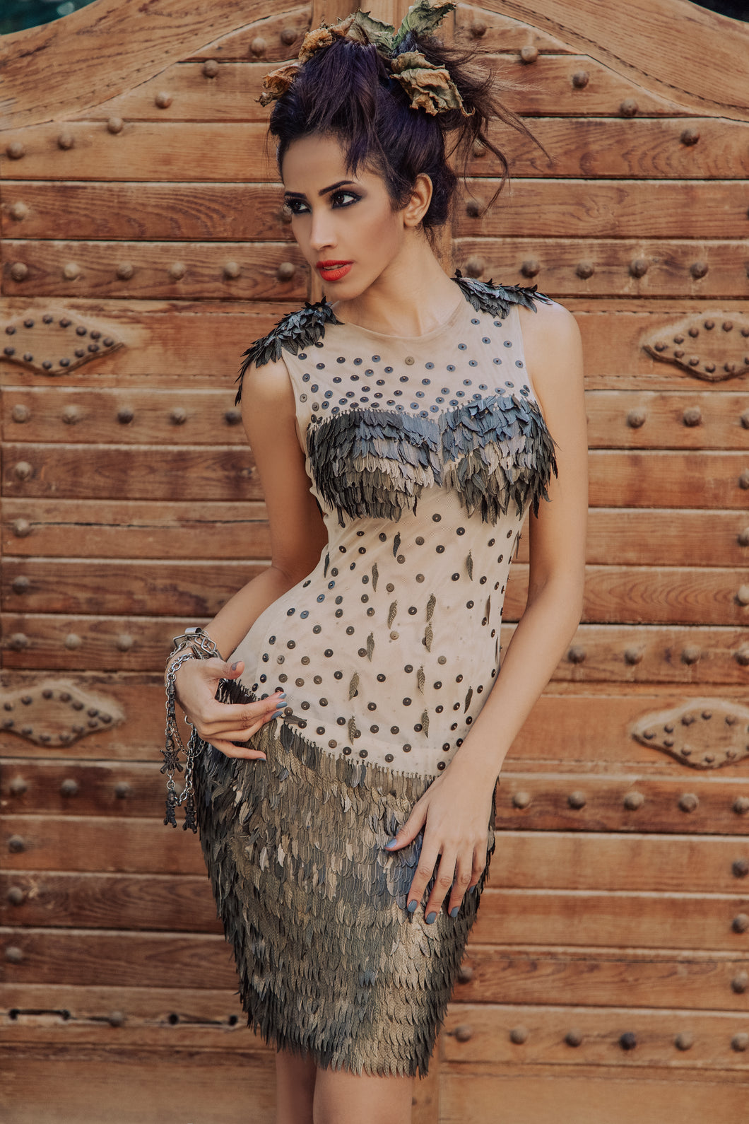 Egyptian Brunette Model With A Nude Gypsy Dress & A Wrapped Up Hair Style With Leaves & Natural Make up on a brown wood door background