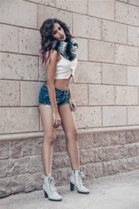 Sexy Brunette Model Long Shot Posing on Wall Street Fashion Style With Jeans Shorts & White Shirt